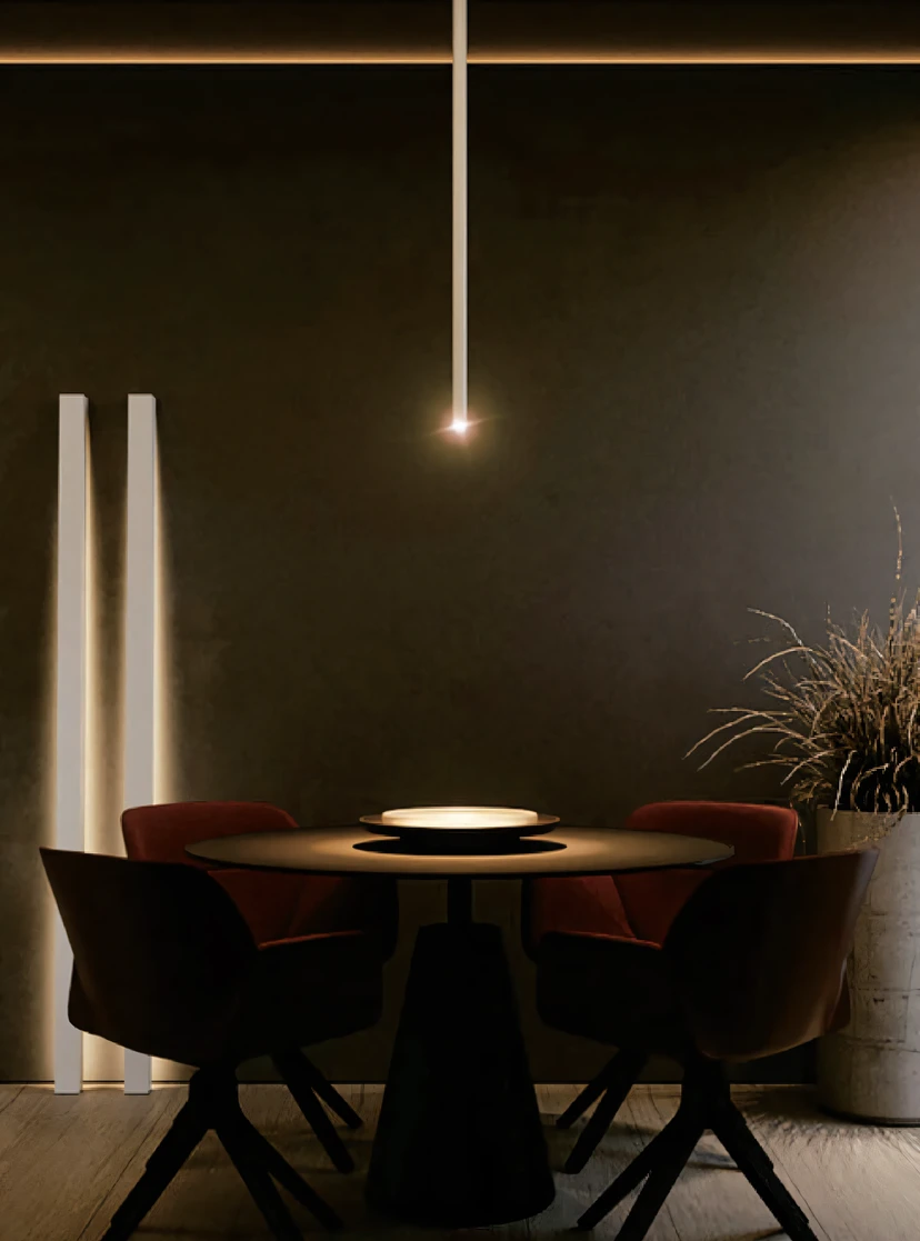 Dark dining corner with a single thread of light over a round table