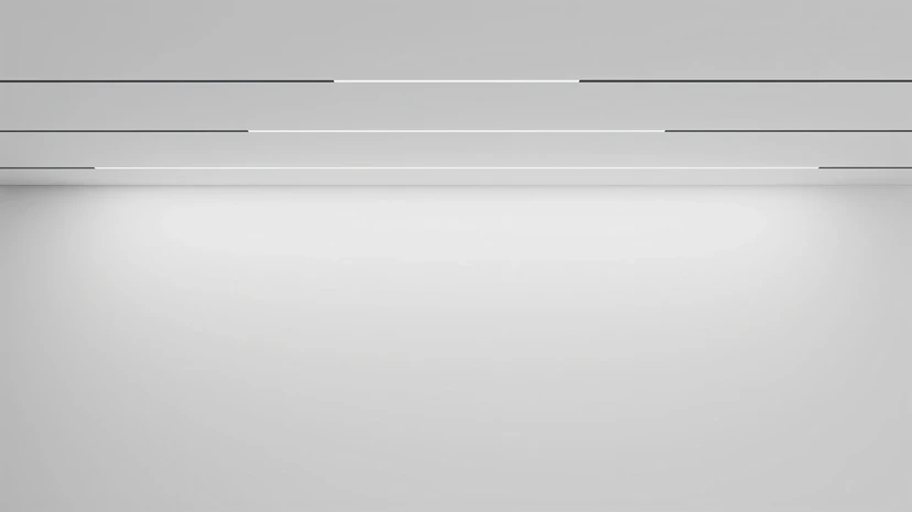 Three fine linear light lines set into a white ceiling, washing the wall below in soft gradient light