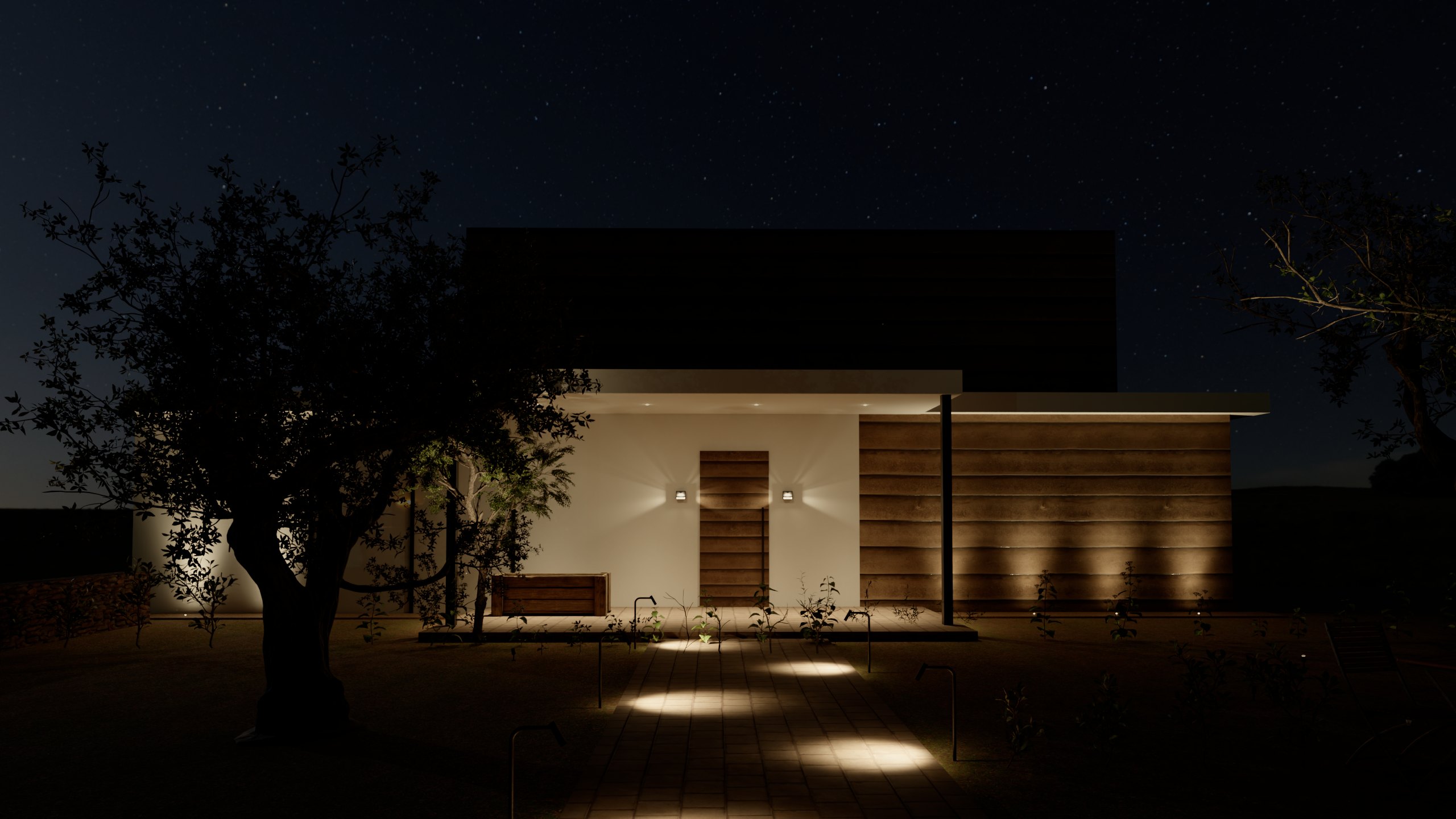 Casa e giardino di notte: paletti lungo il vialetto, incassi a terra che radono la facciata, applique accanto alla porta, downlight nel portico e picchetti che illuminano gli alberi.
