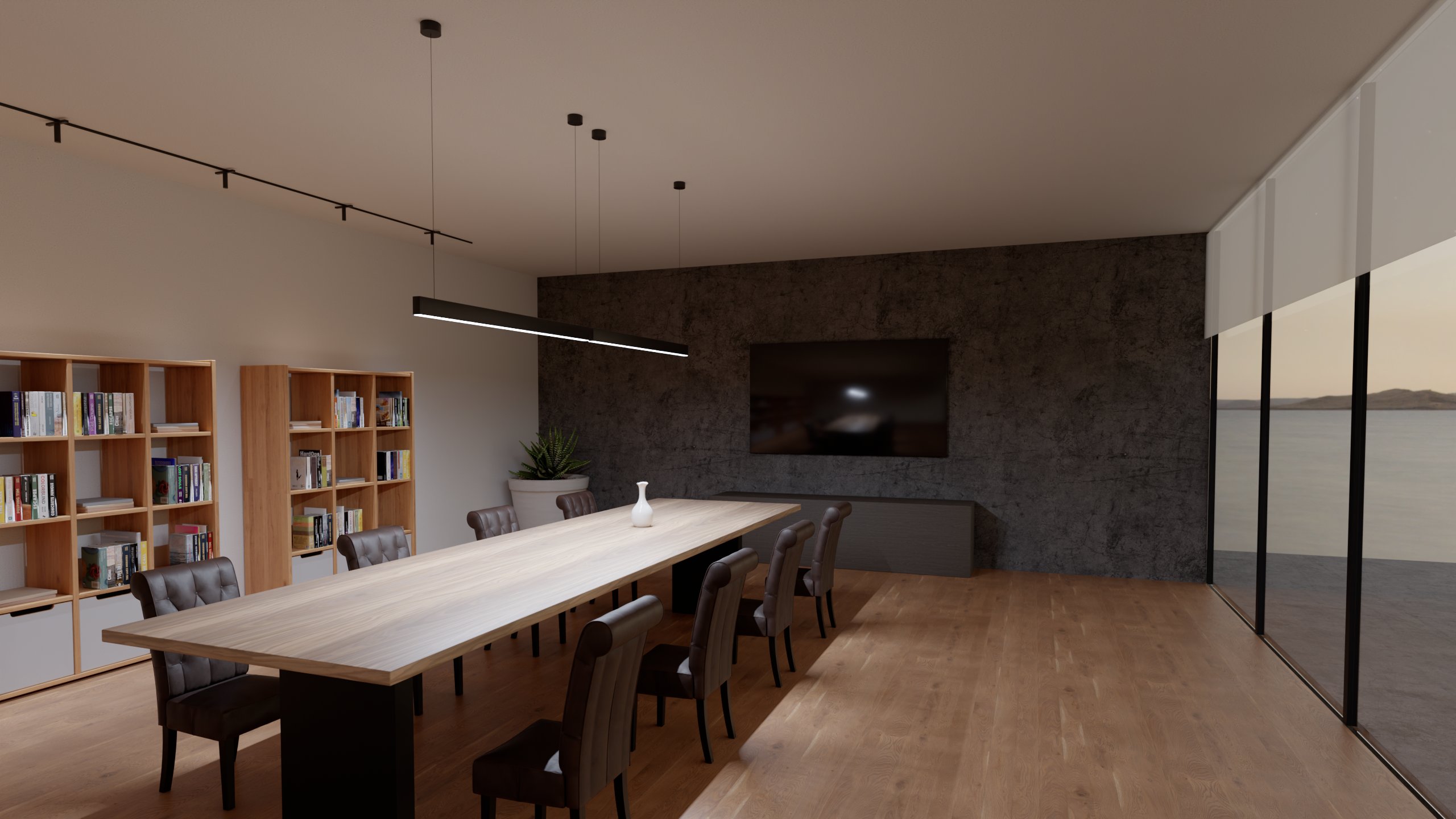 Sala riunioni di sera: due apparecchi lineari a sospensione sul tavolo e downlight su un binario sottile lungo le librerie, il lago oltre la vetrata.